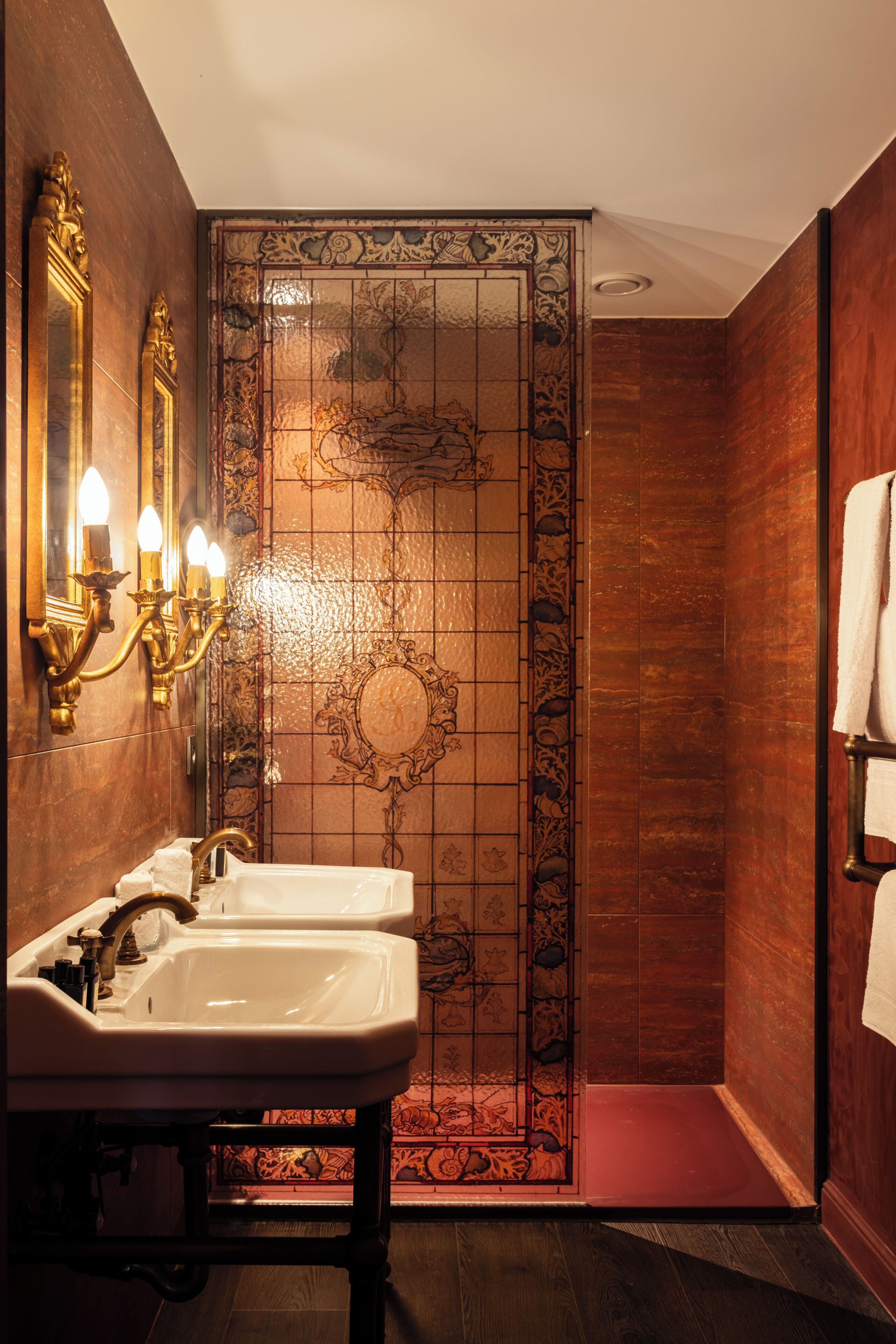 A bathroom with two sinks, a mirror, and a decorative wall panel.