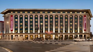 A multi-story building with a prominent sign reading "RAMADA PLAZA."