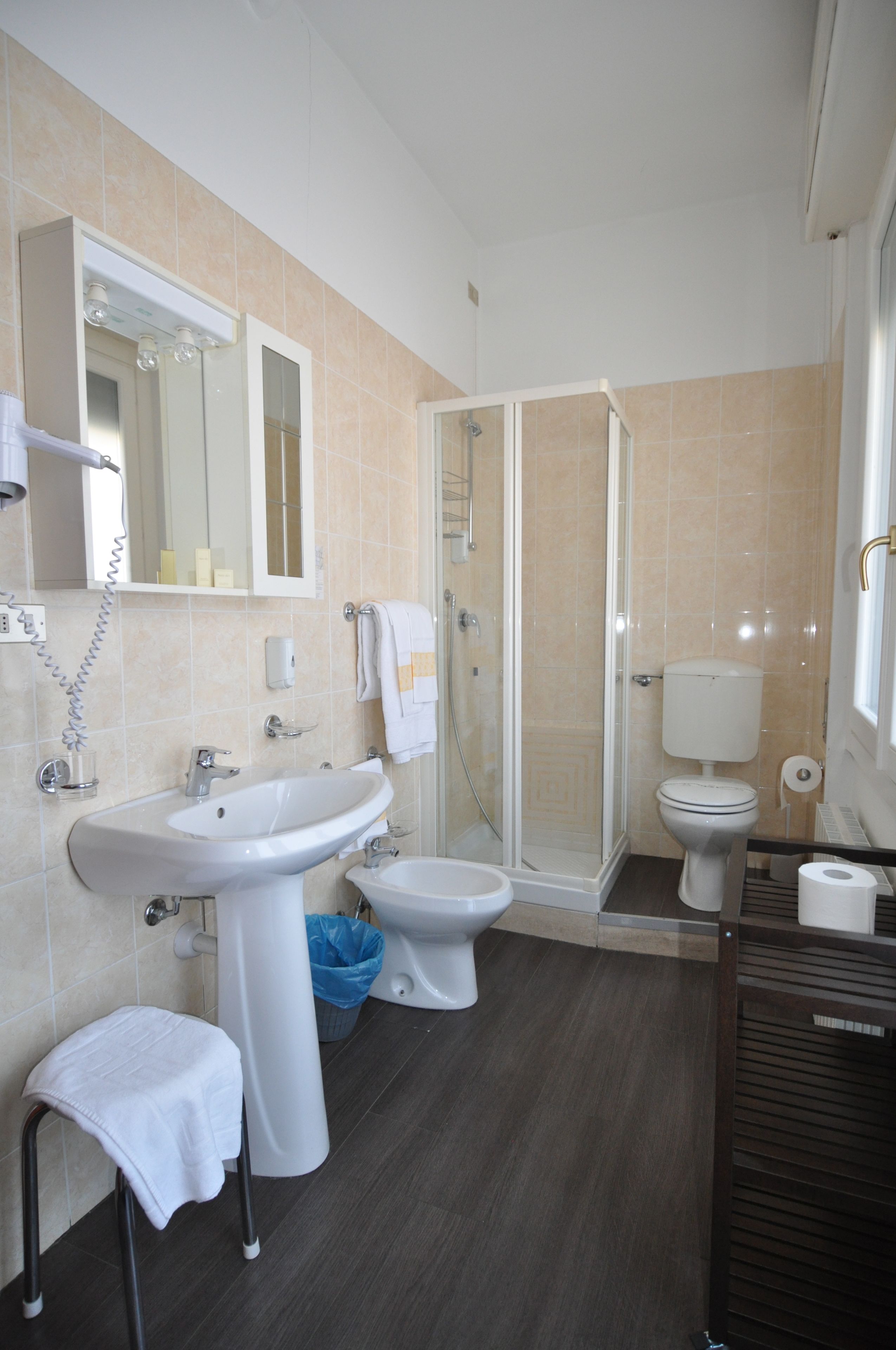 hair dryer, slippers, bidet, towels