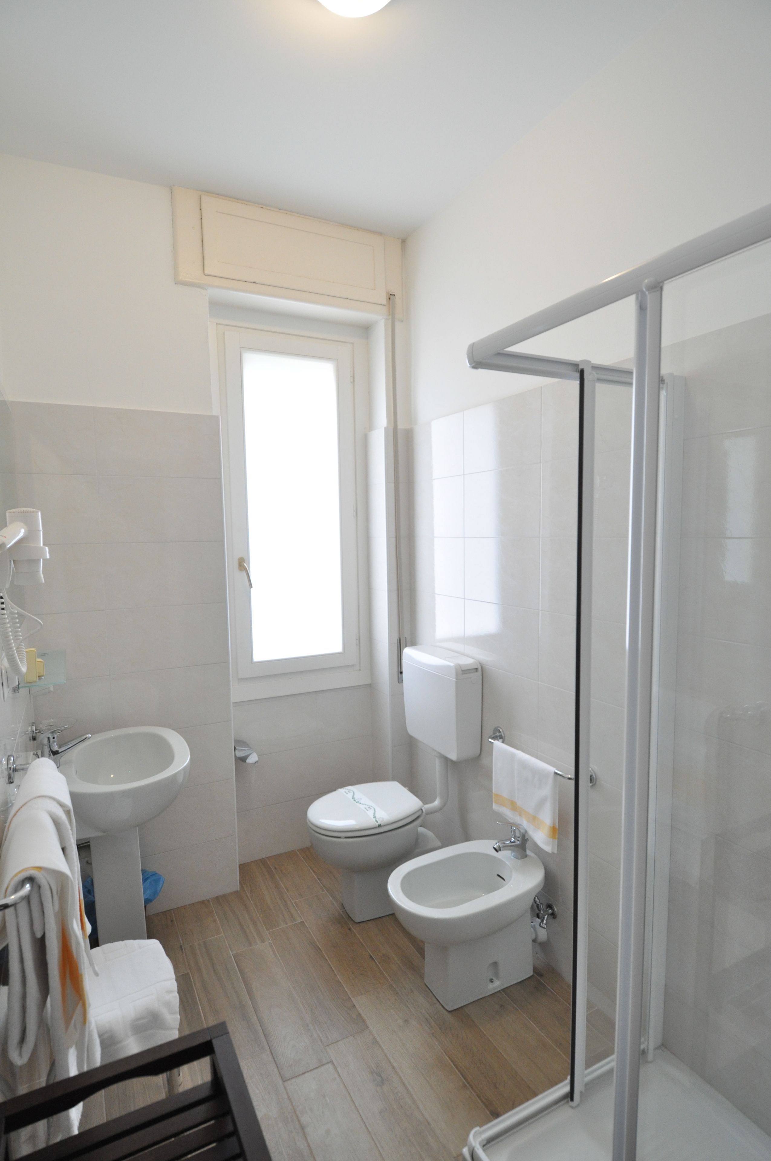 hair dryer, slippers, bidet, towels