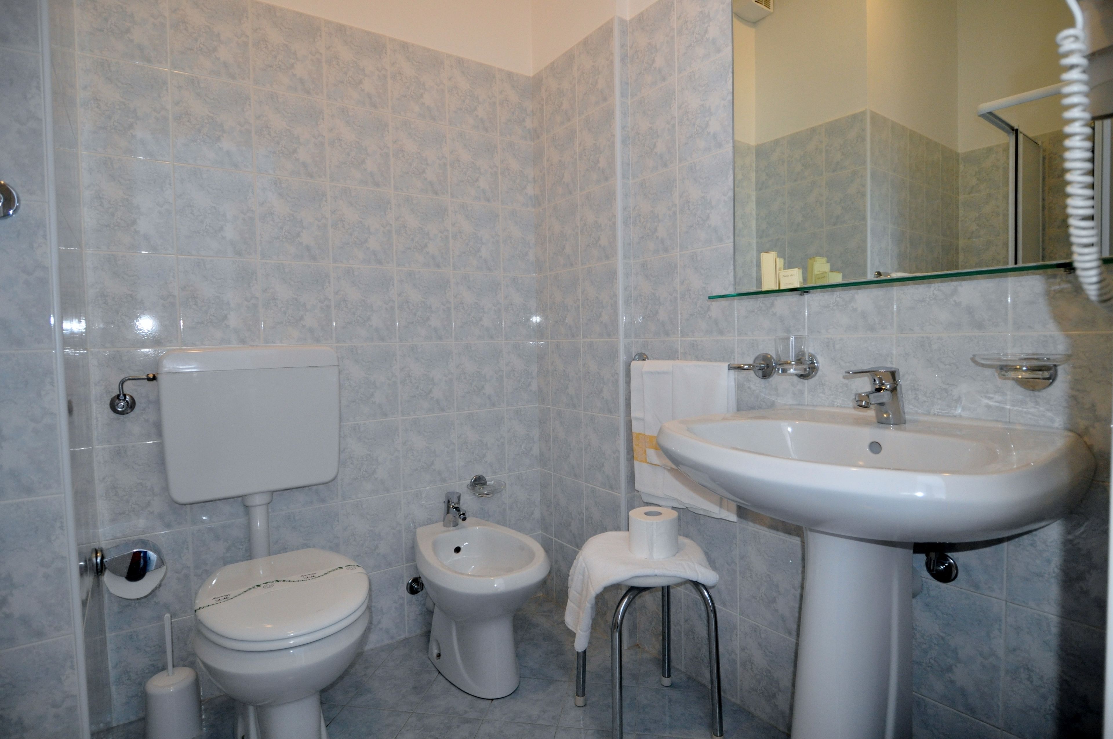 hair dryer, slippers, bidet, towels