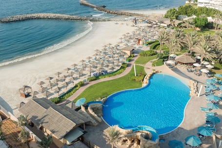 Private beach, white sand, sun-loungers, beach umbrellas. Coral Beach Resort - Sharjah