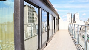 A modern building with large windows and a balcony. - Imperial Park Hotel (Buenos Aires)