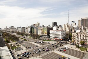 A cityscape with a prominent building featuring a large sign. - Imperial Park Hotel (Buenos Aires)