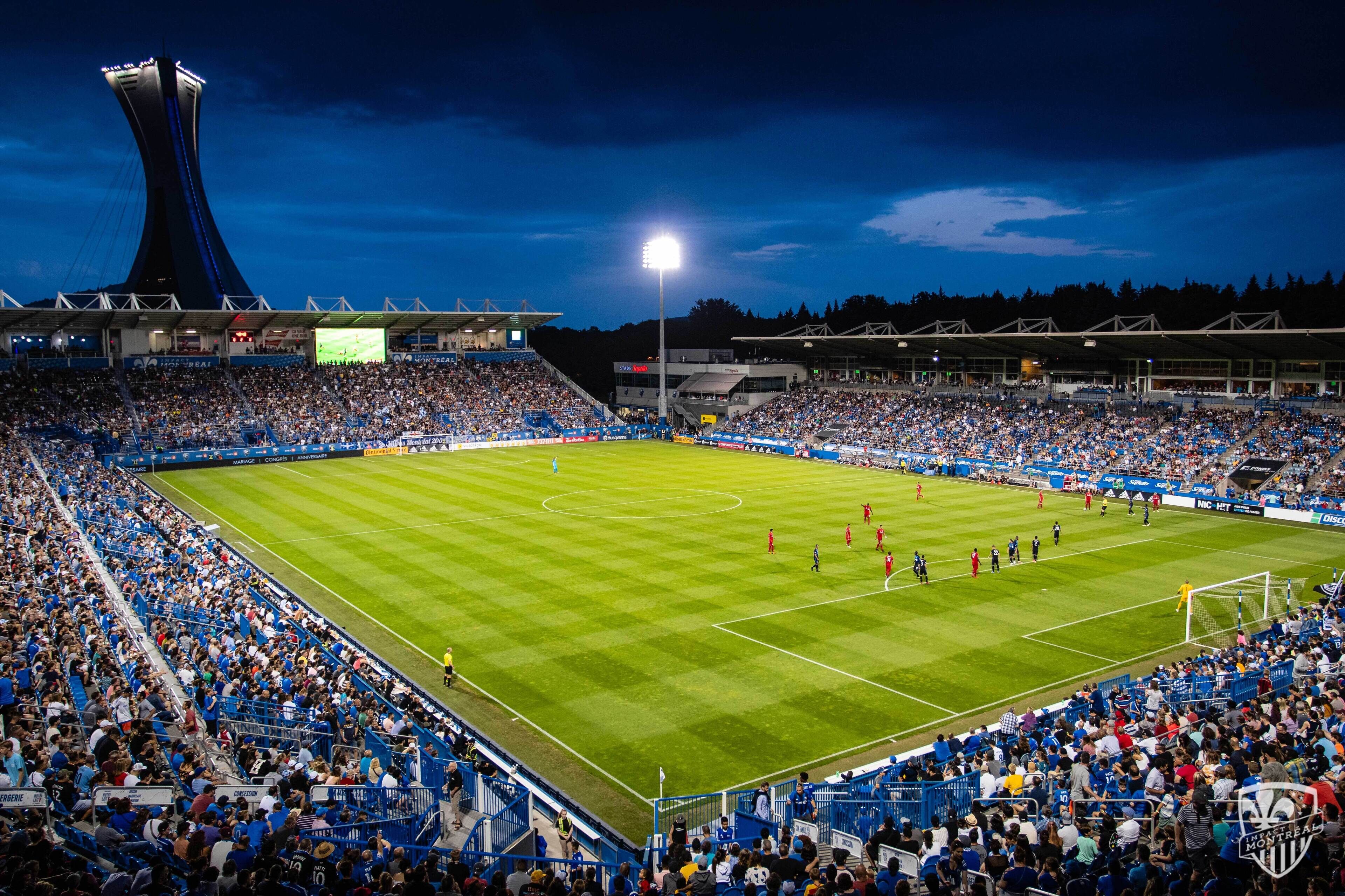 A stadium with a large seating capacity, a central field, and a distinctive tower structure.