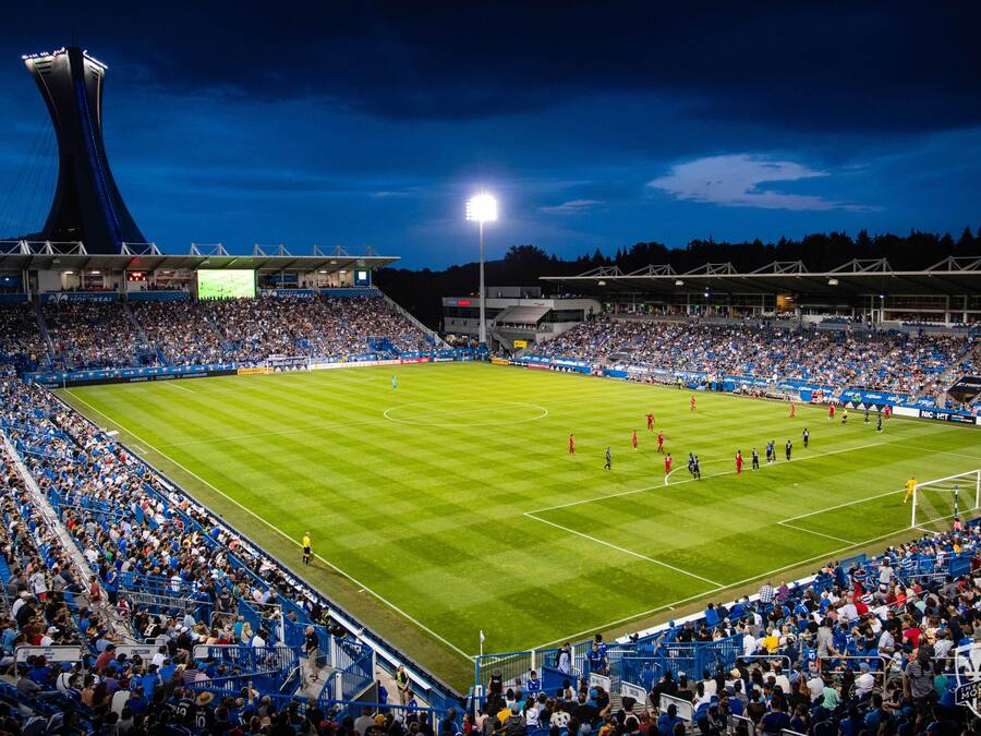A stadium with a large seating capacity, a central field, and a distinctive tower structure.