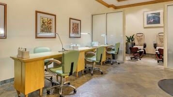 A dental office with a reception desk, three chairs, a computer, and framed artwork on the walls.