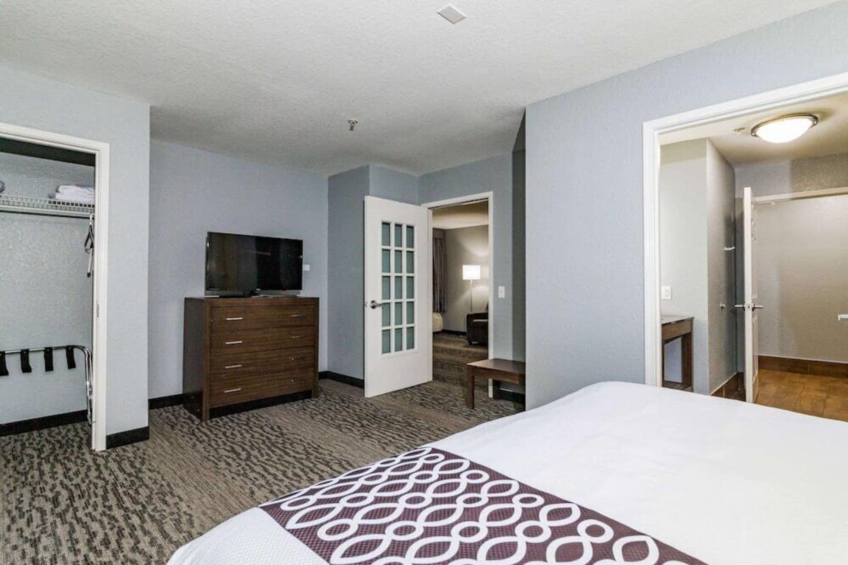 Premium bedding, desk, laptop workspace, iron/ironing board