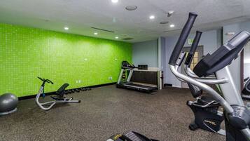 A gym with treadmills, an elliptical, and a stationary bike.