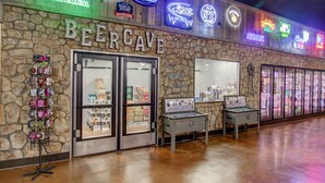 A beer-themed store with a stone facade and various beer brand signs.