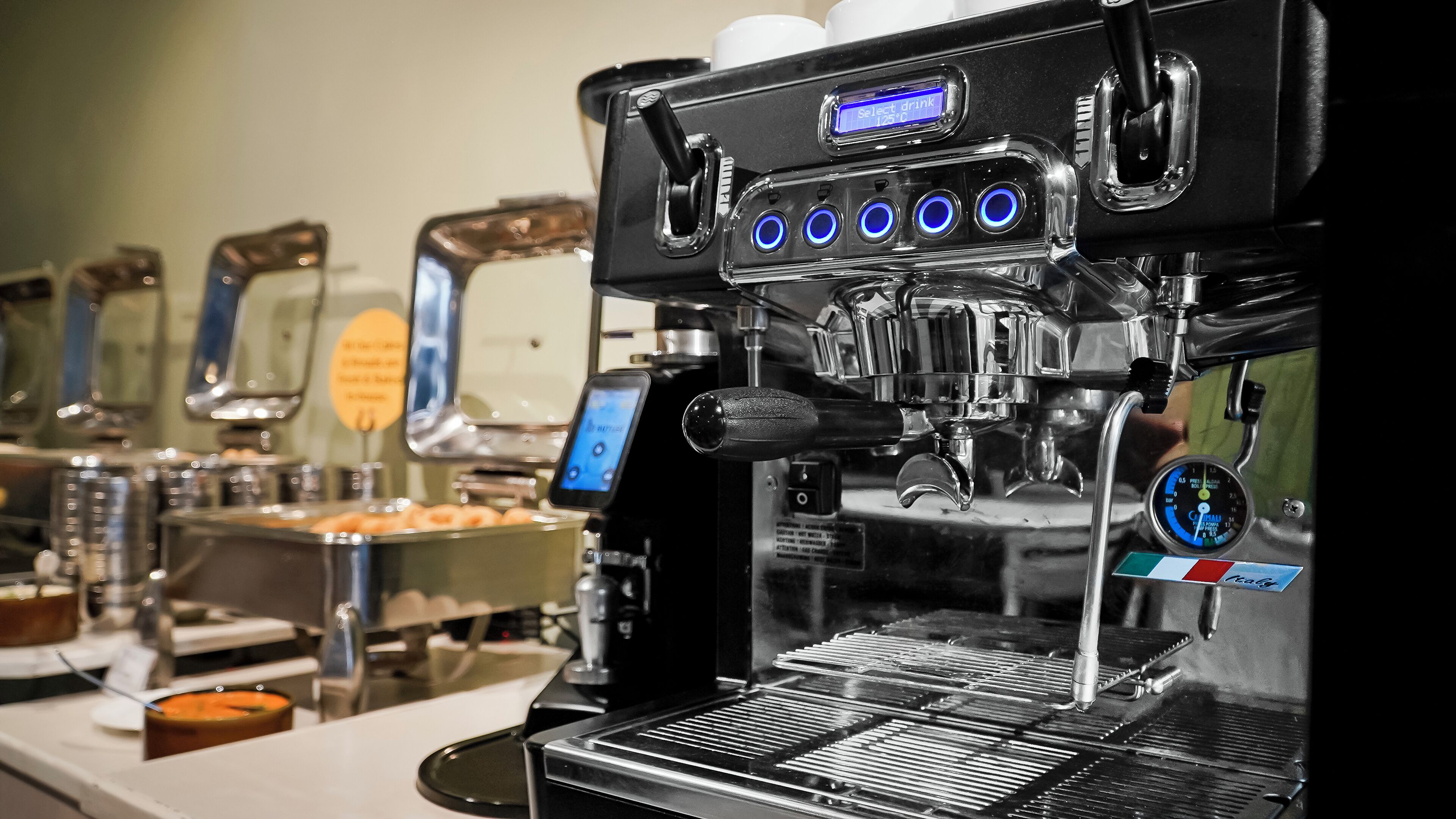 A coffee machine with a digital display and multiple buttons.