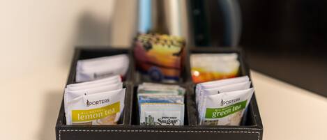 A black leather box containing tea packets labeled 'Lemon Tea' and 'Green Tea'.