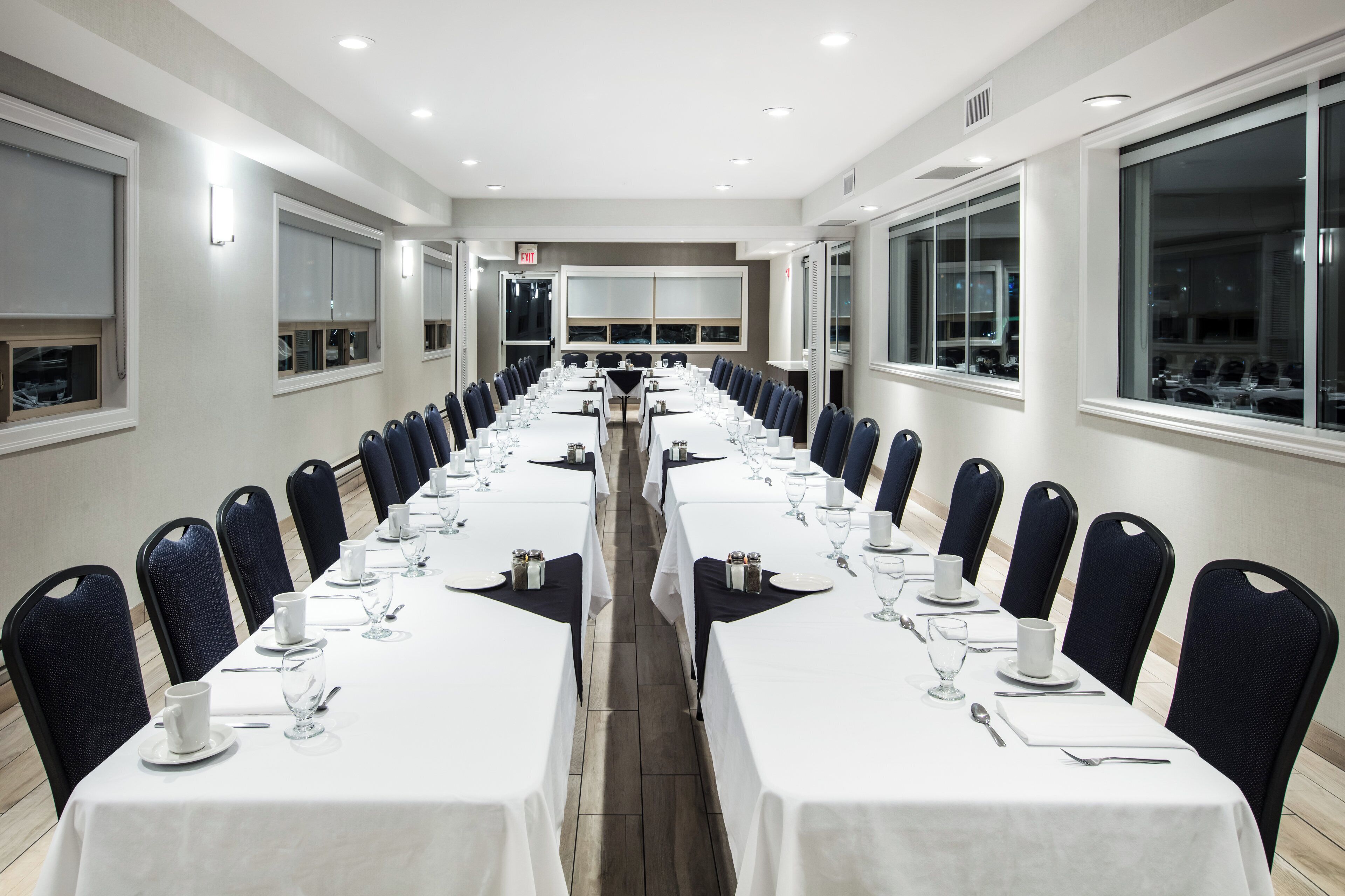 A conference room with long tables set for a meeting.