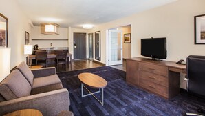 A modern hotel room with a living area, a dining area, and a kitchenette. - Holiday Inn & Suites Grande Prairie Conference Center by IHG (Grande Prairie)