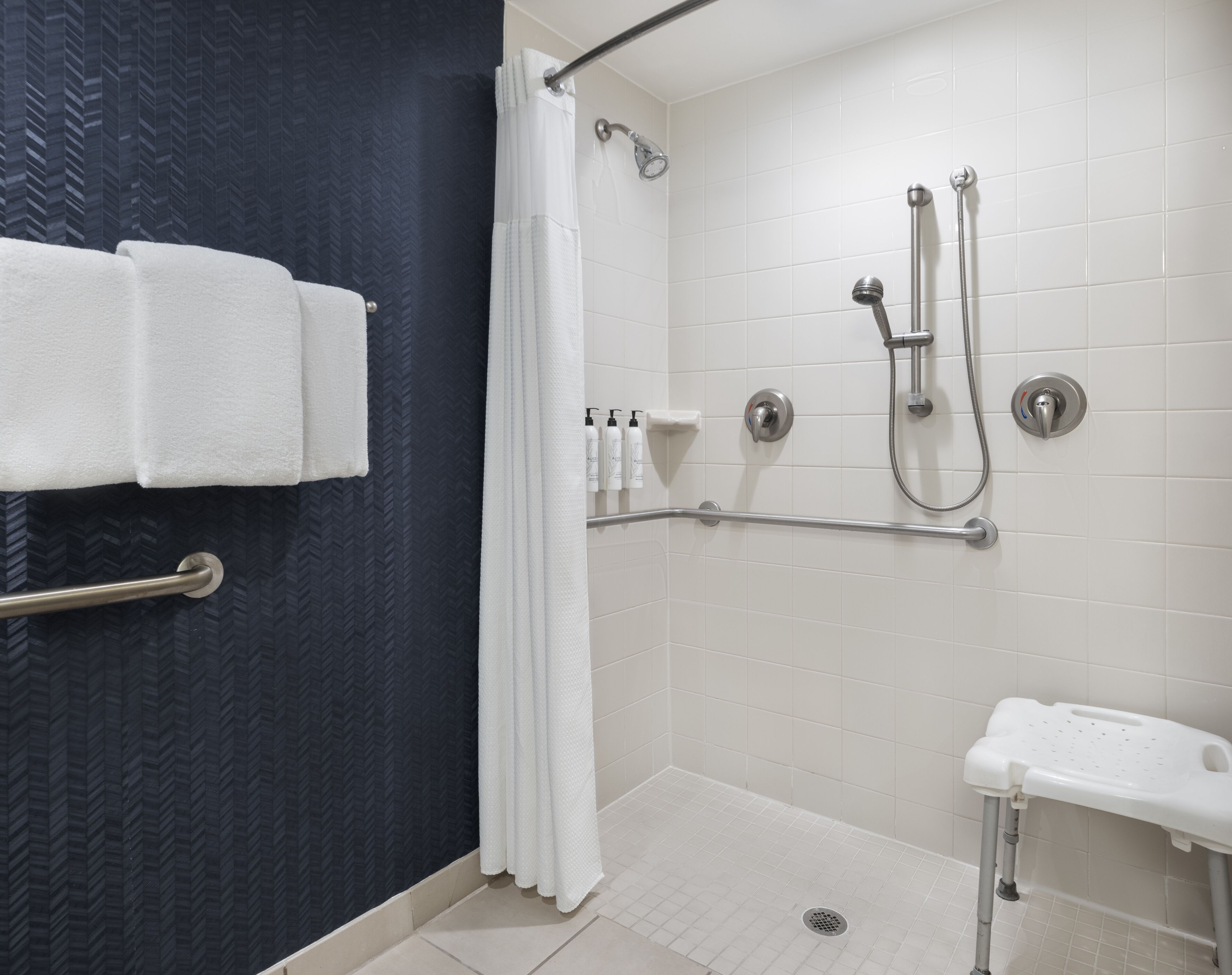 combined shower/bathtub, designer toiletries, hair dryer, towels