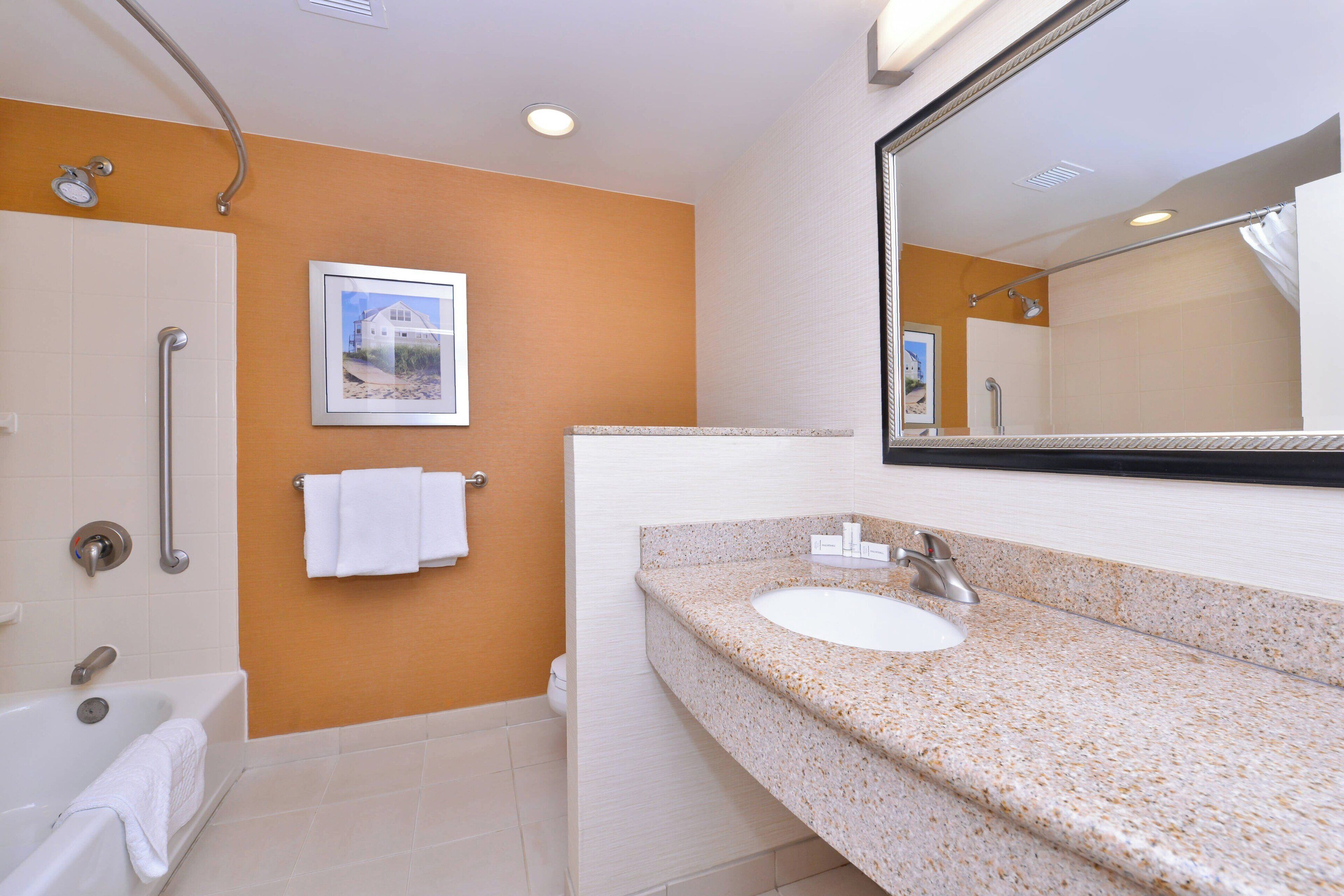 combined shower/bathtub, designer toiletries, hair dryer, towels