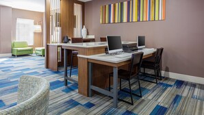 A modern conference room with a large table, chairs, and a computer setup. - Holiday Inn Express & Suites Newport News by IHG (Newport News)