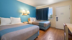A hotel room with two beds, a nightstand, a desk, and a window with curtains. - Motel 6 Grand Junction, CO (Grand Junction)