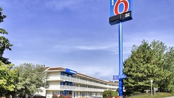 Welcome to the 6 Motel, a two-story retreat with a balcony and a convenient entrance.