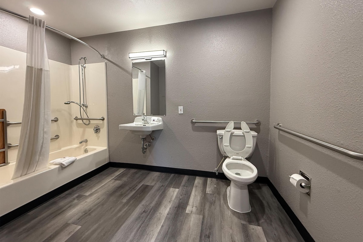 A bathroom with a bathtub, a sink, a toilet, and a shower.