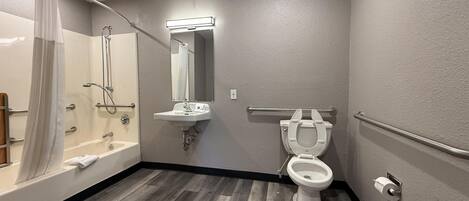 A bathroom with a bathtub, a sink, a toilet, and a shower.