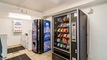 A vending machine area with a water dispenser and snack options.