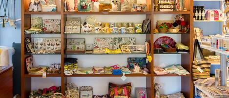 A store with shelves of various bags, purses, and accessories.
