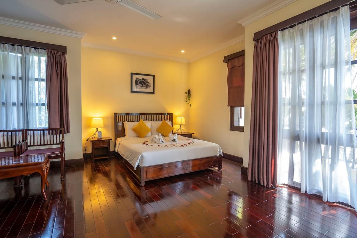 Suite, River View | Minibar, in-room safe, desk, blackout drapes