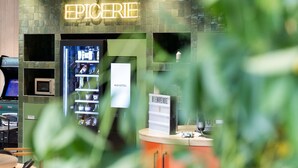 A hotel reception area with a neon sign reading "EPICERIE" and a "NOVOTEL" sign. - Novotel Paris 13 Porte d'Italie (Le Kremlin-Bicetre)