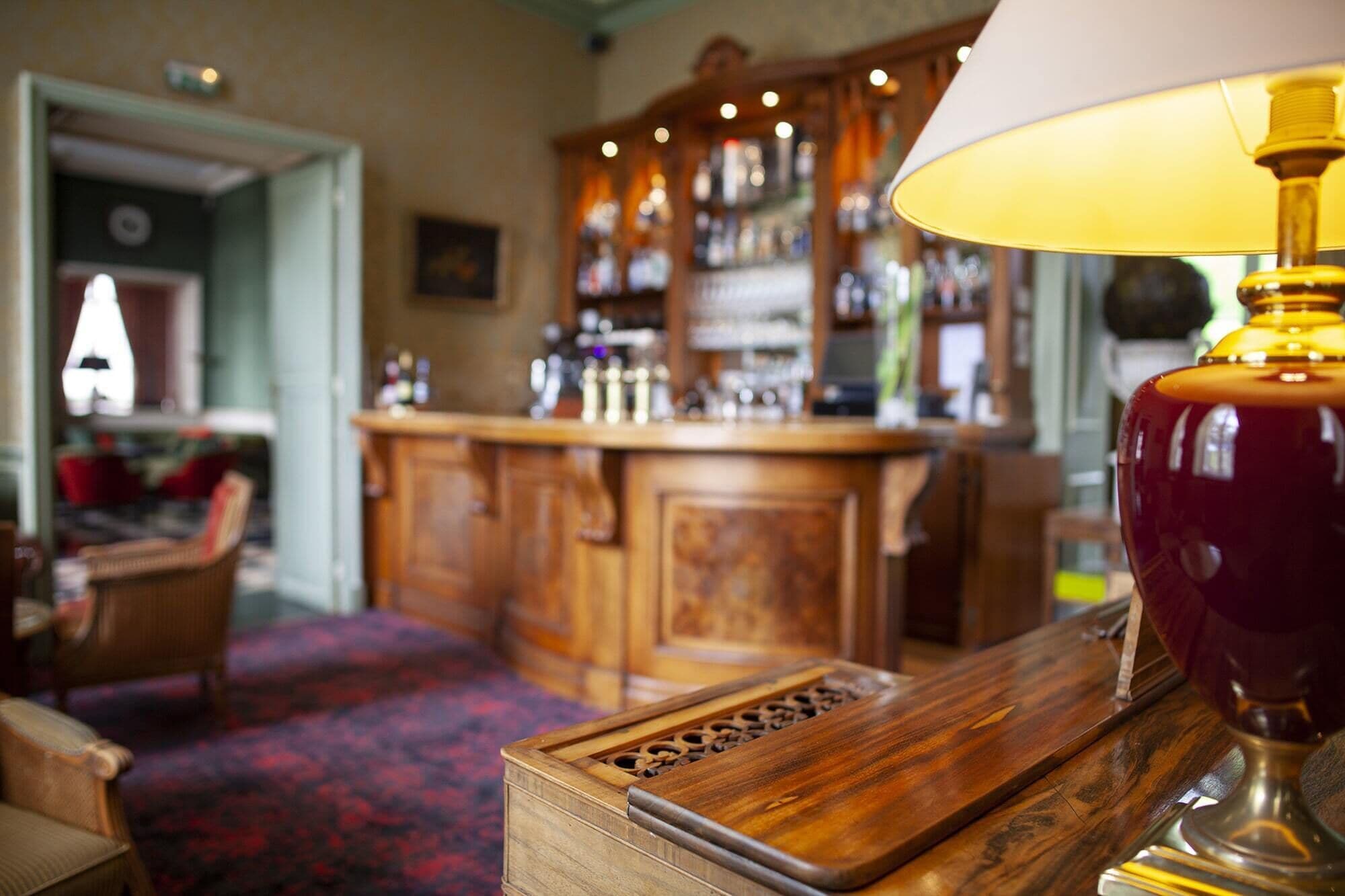 A bar area with wooden cabinets and a patterned carpet.