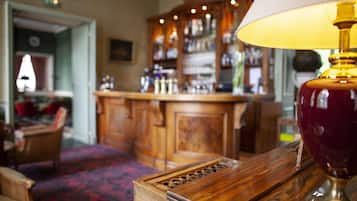 A bar area with wooden cabinets and a patterned carpet.