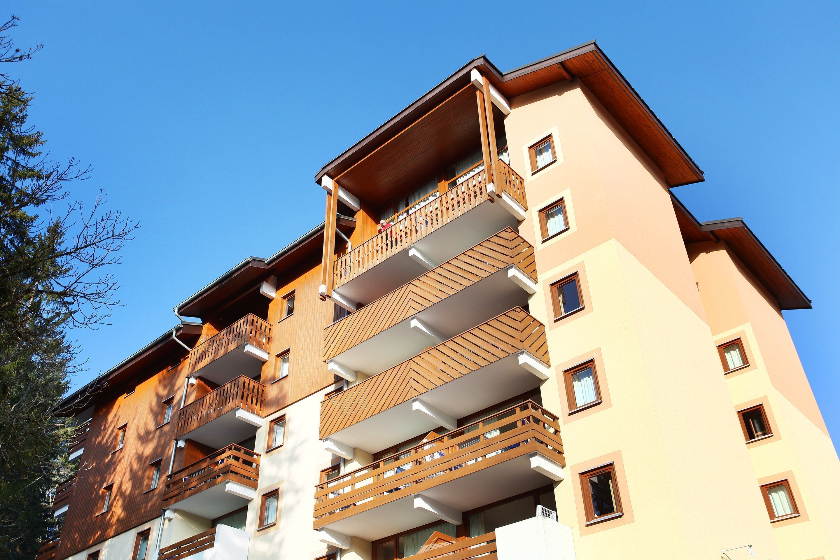 A multi-story building with balconies and windows.