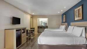A hotel room with a bed, a desk, a chair, a TV, and a mirror. - SureStay Hotel by Best Western San Rafael (San Rafael)