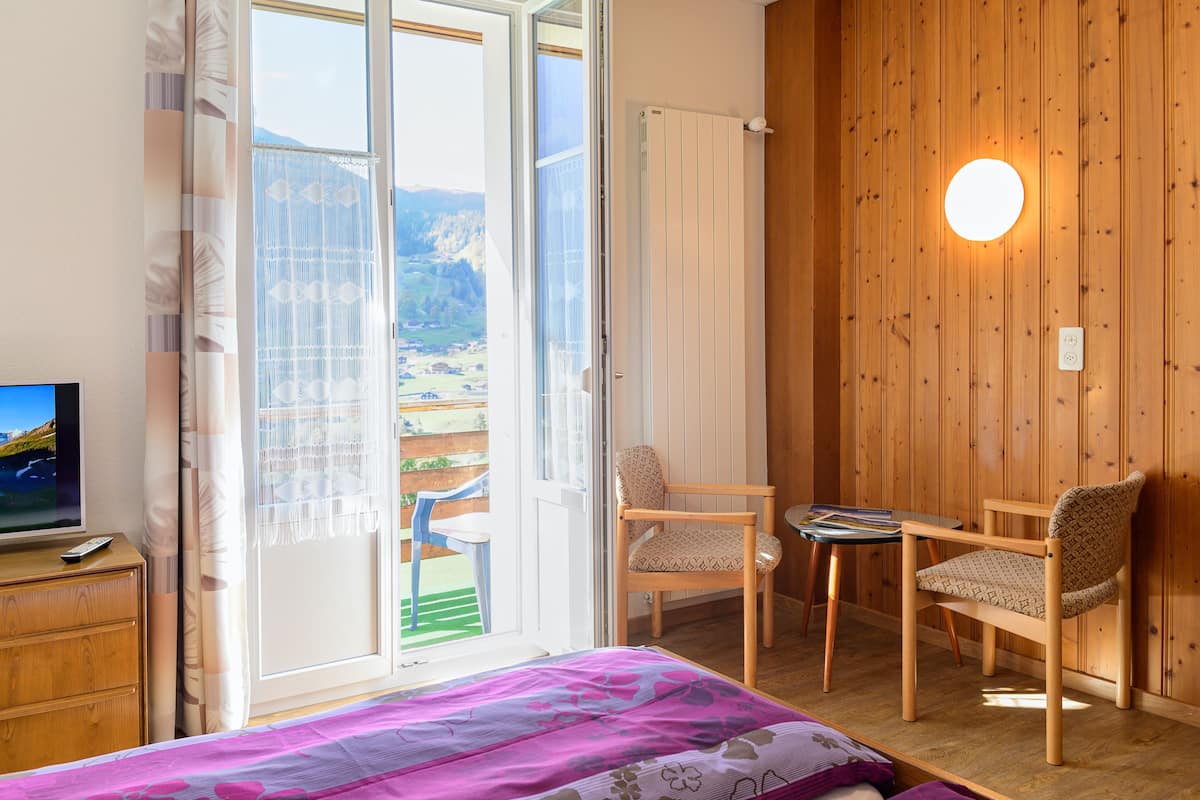 twin room, balcony, mountain view | living area | flat-screen tv