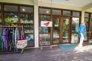 Welcome to our boutique hotel, featuring a stylish entrance with a clear view of the interior through large glass windows and doors.