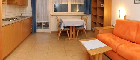 A compact living space with a kitchen, dining area, and seating area.