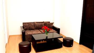 Deluxe suite, balkon | Woonruimte | Een 50-inch flatscreentelevisie met satellietzenders en een televisie