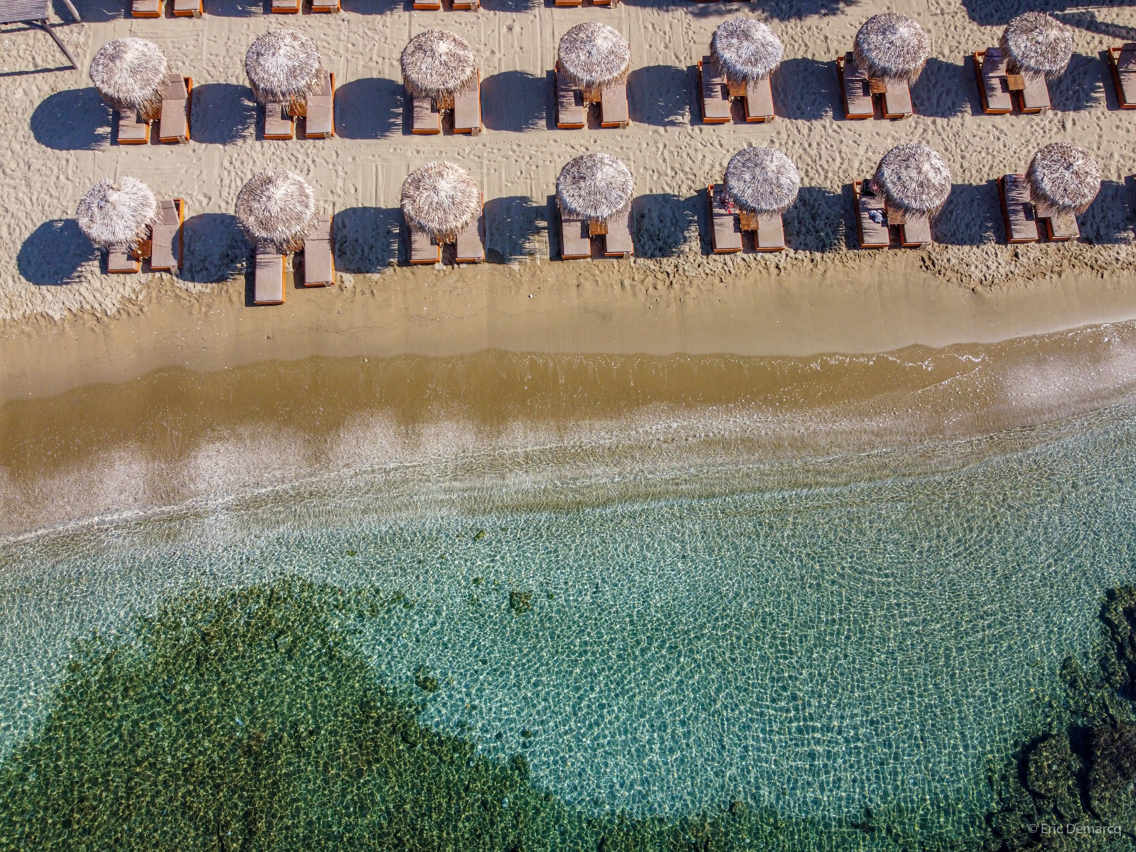 On the beach, white sand, sun loungers, beach umbrellas
