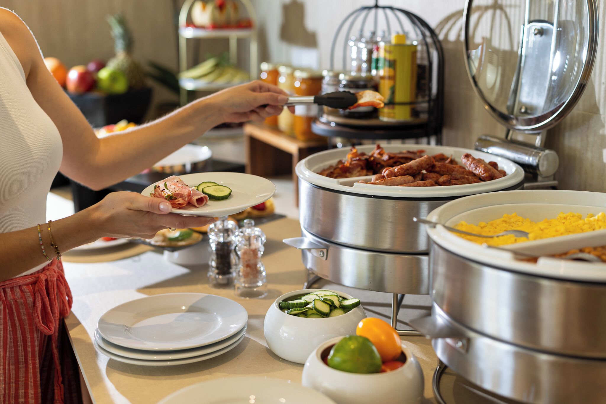 A buffet setup with various dishes and a large pot of food.