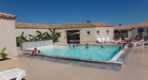 Seasonal outdoor pool, open 10:00 AM to 7:00 PM, pool loungers