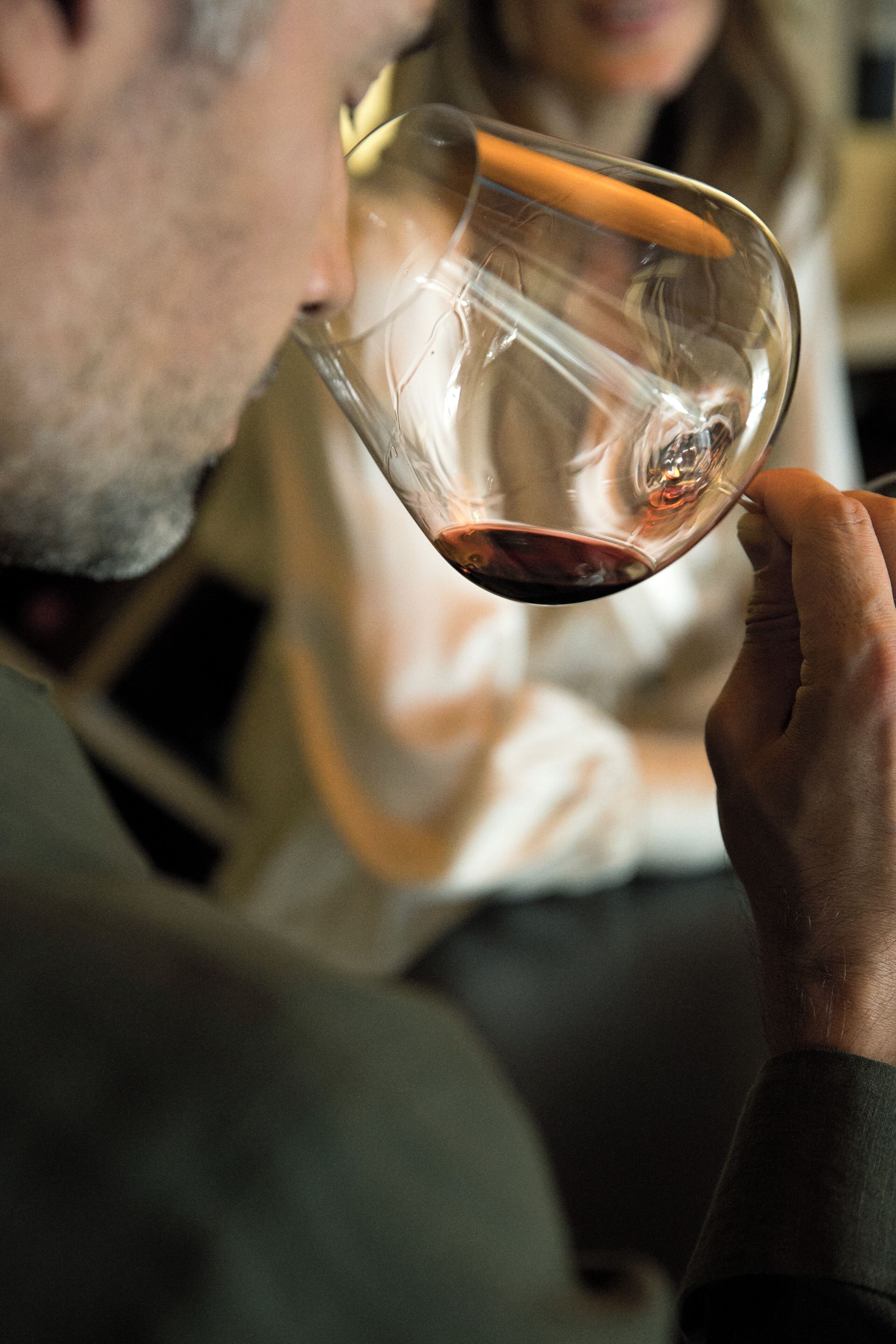 A person holding a wine glass.