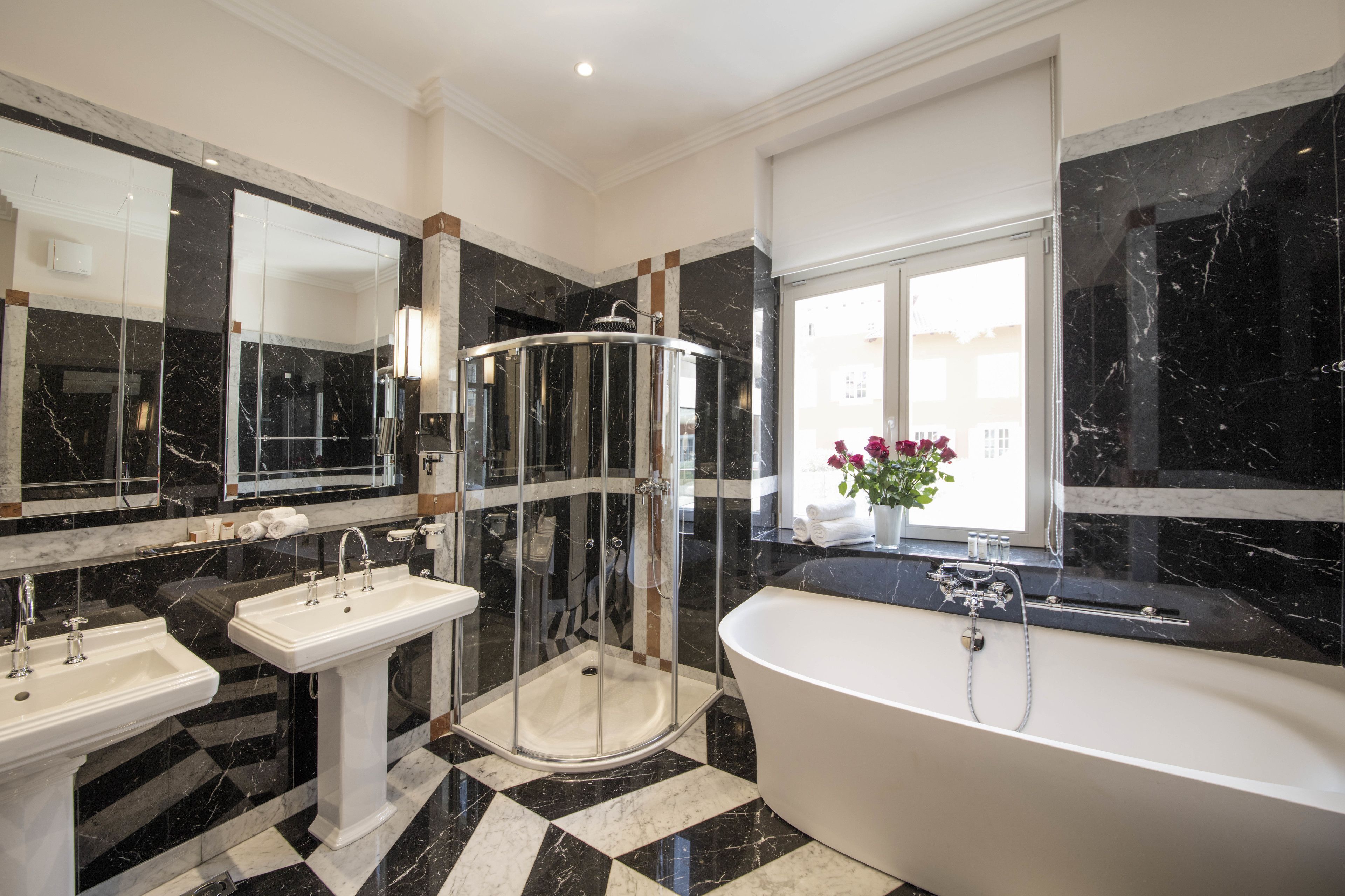 executive suite | bathroom | combined shower/bathtub, designer toiletries, hair dryer, bathrobes