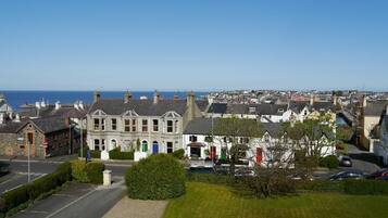 A coastal town with a prominent building featuring a bay window and a traditional facade.