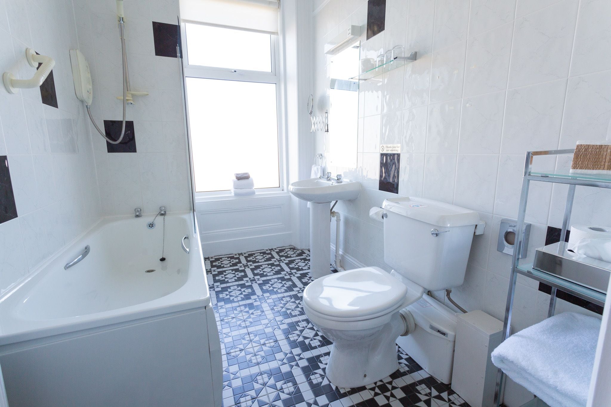 A bathroom with a bathtub, toilet, and sink.
