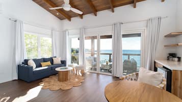Suite 14 - Presidential Suite | Living area | 55-inch Smart TV with cable channels, TV, books