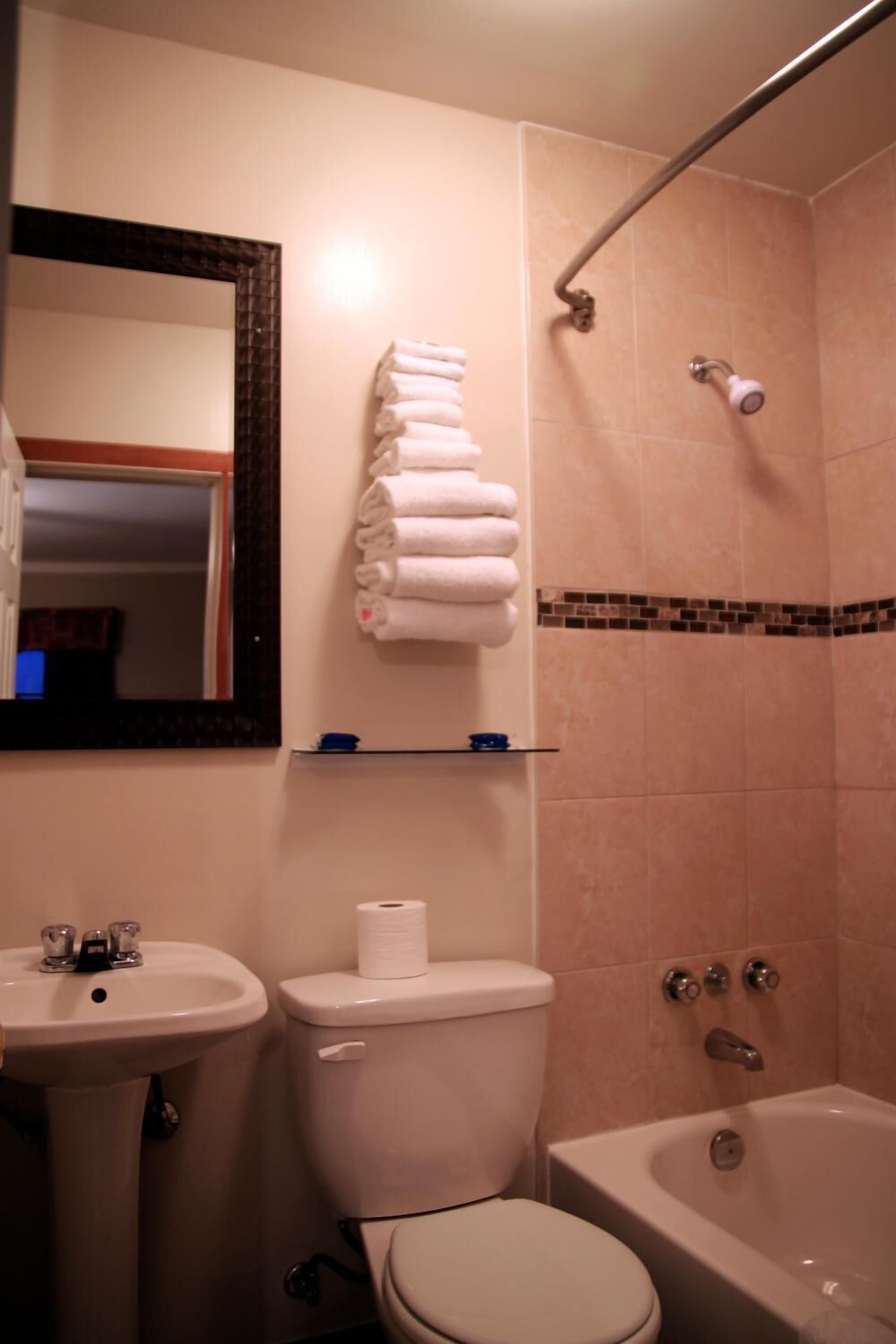 A bathroom with a sink, toilet, and bathtub.