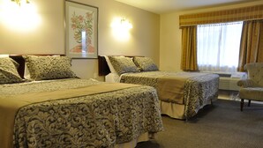 A hotel room with two beds, a chair, and a large window with curtains. - Rosedale Motel (Summerland)