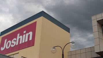A building with a large 'Joshin' sign on its facade.