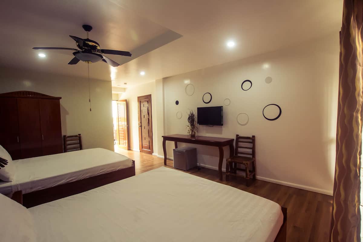 deluxe room, 2 queen beds, partial ocean view | in-room safe, desk, soundproofing, iron/ironing board