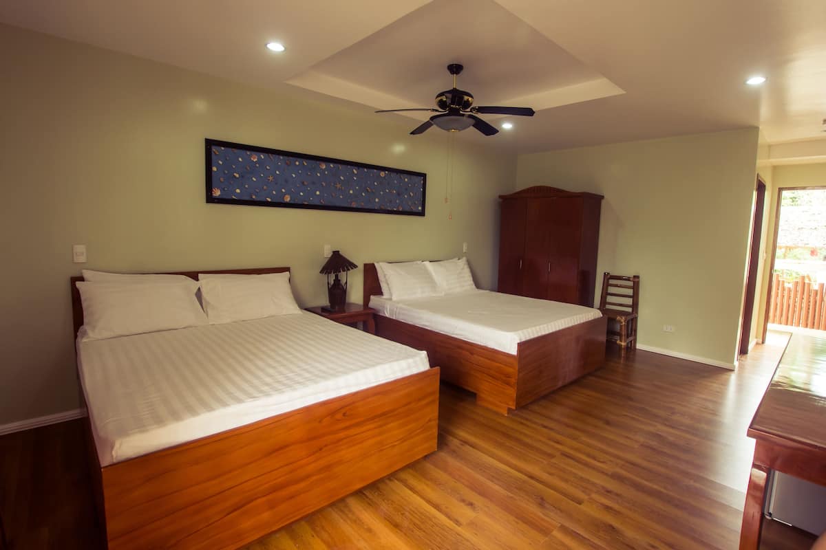 deluxe room, 2 queen beds, partial ocean view | in-room safe, desk, soundproofing, iron/ironing board